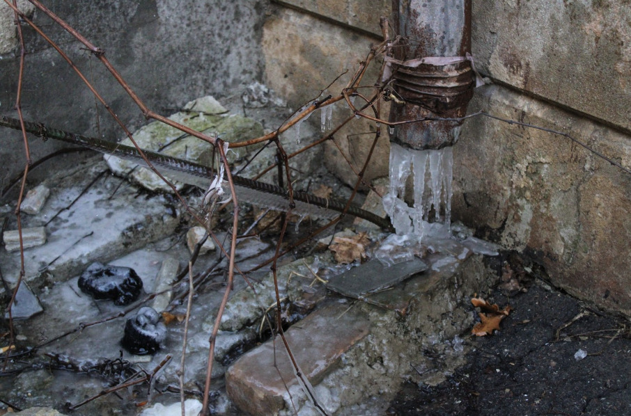 frozen water protruding from a drainpipe outside